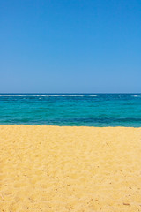 Fototapeta na wymiar colorful beach with sand and sea and blue sky