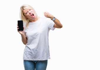 Fototapeta premium Young beautiful blonde woman showing screen of smartphone over isolated background annoyed and frustrated shouting with anger, crazy and yelling with raised hand, anger concept