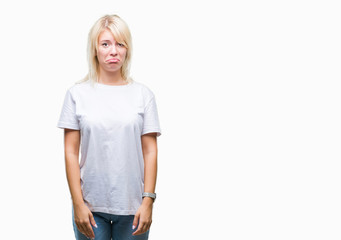Fototapeta premium Young beautiful blonde woman wearing white t-shirt over isolated background depressed and worry for distress, crying angry and afraid. Sad expression.