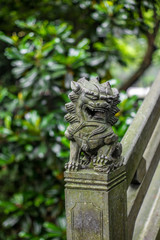 Fototapeta premium Detail of a small chinese lion sculpture on a stone bridge in a park in Wenzhou in China - 1