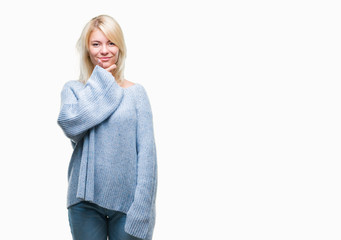 Young beautiful blonde woman wearing winter sweater over isolated background looking confident at the camera with smile with crossed arms and hand raised on chin. Thinking positive.