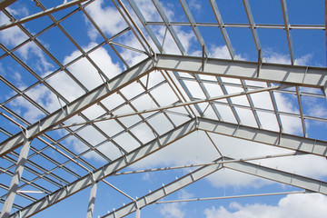 Naklejka premium The structure of the building. Steel construction on the sky background. Electroplate steel metal. Zinc metal coating to protect against corrosion.