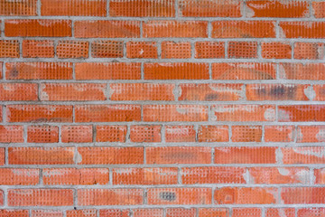 Brickwork in the construction of a new high-rise building. The use of traditional building materials.