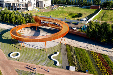 Urban landscape. Two-level orange platform in the form of a spiral for Hiking. The view from the...