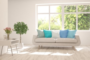 Stylish room in white color with sofa and summer landscape in window. Scandinavian interior design. 3D illustration