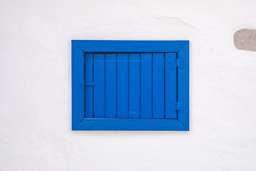 View of white street and flowers in Bodrum city of Turkey. Aegean style colorful street, wall, house and flowers in Santorini, Mykonos / Greece. White wall and blue window.