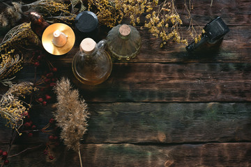 Witchcraft background with copy space. Magic potions and dried herbs on a witch doctor table.