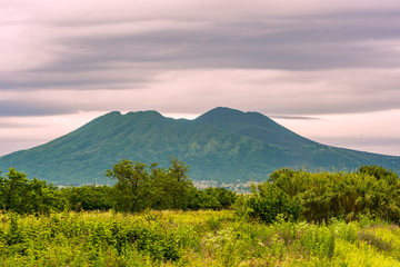 Fototapeta premium close-up of the Vesuvius during a cloudy day with a frame of green vegetation