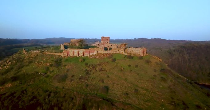 Aerial drone parallax tracking left shot flying towards the Hammershus Castle Ruins in Scandinavia, Hammeren, Bornholm Island, Denmark