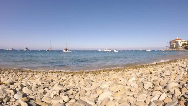 Low angle timelapse of rocky beach and boats on Catalina Island