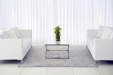 Interior of the living room of the hotel. Beautiful living room with white sofa. White Concept Living Room Interior. Modern bed room interior in Luxury villa. White colours, big window