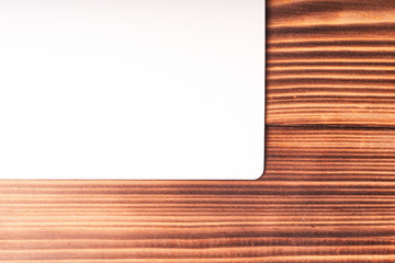 A sheet of white paper on a wooden table