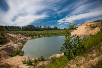 Fototapeta na wymiar Blue sky and lake in the sand quarry