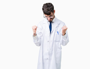 Young professional scientist man wearing white coat over isolated background very happy and excited doing winner gesture with arms raised, smiling and screaming for success. Celebration concept.