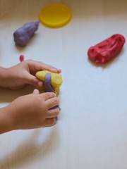 kids playing with play dough over white background