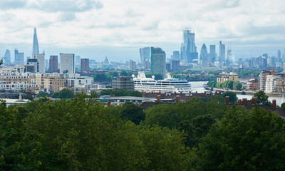 LONDON, ENGLAND/UNITES KINGDOM –– JUNE 11 2019: View of London from Greenwich park at cloudy summer day