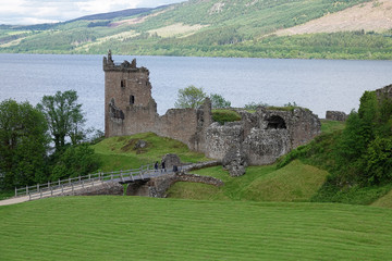 Drumnadrochit, Inverness, Scotland - June 10, 2019: Located next to the legendary lake, Loch Ness, Urquhart Castle is shown during the day. The remaining ruins date from the 13th to 16th centuries.