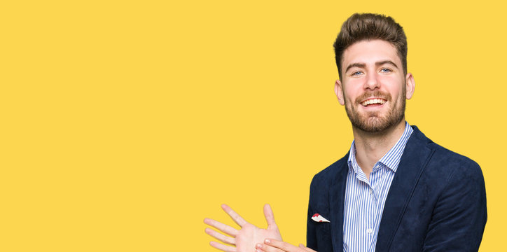 Young handsome bussines man Clapping and applauding happy and joyful, smiling proud hands together