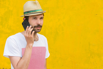 man talking on a cell phone on an old yellow background