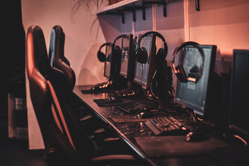 Empty comfortable studio for professional gamers with computers and earphones.