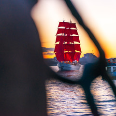 Ship with red sails sails on the Neva. Preparation for the holiday of all schoolchildren "Scarlet Sails" in St. Petersburg