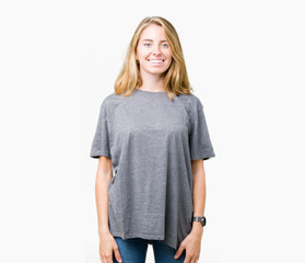 Fototapeta premium Beautiful young woman wearing oversize casual t-shirt over isolated background with a happy and cool smile on face. Lucky person.