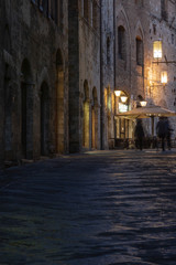 Naklejka premium Medieval streets of San Gimignano at night, Tuscany, Italy