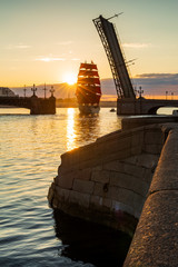Ship with red sails sails on the Neva. Preparation for the holiday of all schoolchildren "Scarlet Sails" in St. Petersburg
