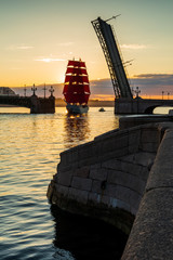 Ship with red sails sails on the Neva. Preparation for the holiday of all schoolchildren "Scarlet Sails" in St. Petersburg