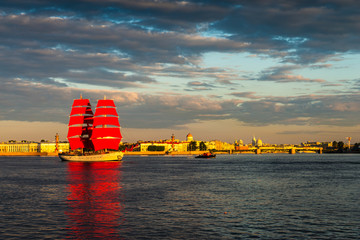 Ship with red sails sails on the Neva. Preparation for the holiday of all schoolchildren "Scarlet Sails" in St. Petersburg