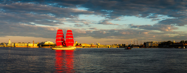 Ship with red sails sails on the Neva. Preparation for the holiday of all schoolchildren "Scarlet Sails" in St. Petersburg