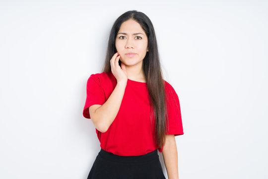 Beautiful brunette woman wearing red t-shirt over isolated background touching mouth with hand with painful expression because of toothache or dental illness on teeth. Dentist concept.