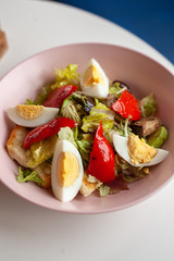 Traditional american cobb salad with chopped avocado, tomatoes, hard boiled egg, roasted chicken and greens for a healthy lunch
