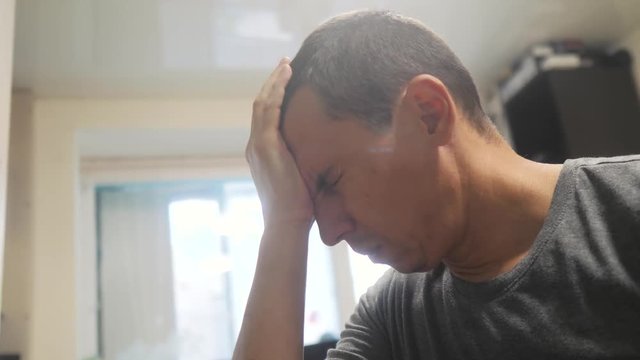 middle-aged man tired big problems at work going through experiencing stress. man unhappy holding his head. depression bankruptcy in business concept. bankrupt upset because of lifestyle work