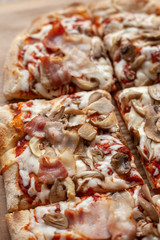 Macro close up of a roman square pizza on thick dough with champignons and a lot of cheese, served on craft paper