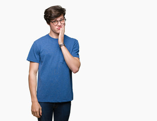 Young handsome man wearing glasses over isolated background thinking looking tired and bored with depression problems with crossed arms.