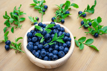 Freshly harvested forest berries in a wooden bowl