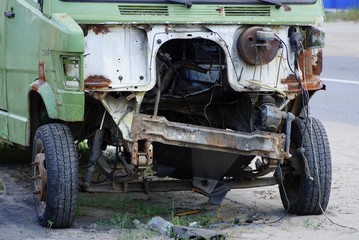 disassembled cabin of an old car on wheels with details on the road