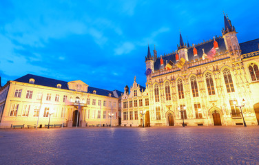 Scenic cityscape with the night medieval Burg Square in Bruges, Belgium.