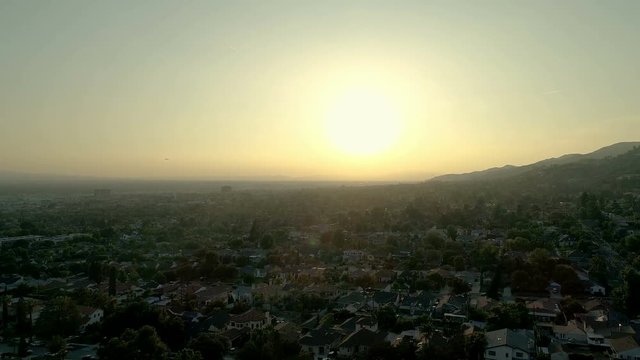 Beautiful aerial drone shot of Burbank, CA as plane takes off - 4K UHD