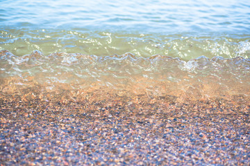 Sea water splashing on a rocky beach
