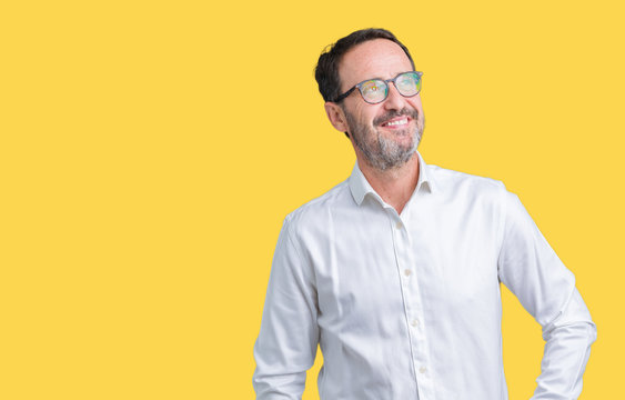 Handsome middle age elegant senior business man wearing glasses over isolated background smiling looking side and staring away thinking.