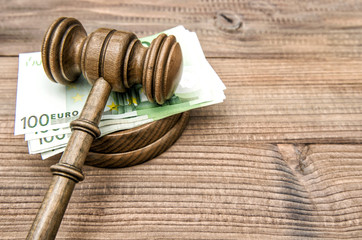 Auctioneer hammer Judges gavel euro banknotes