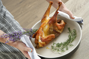 Whole homemade baked organic chicken in the trey with lavender and rosemary