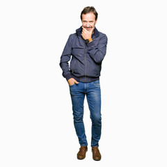 Fototapeta premium Middle age handsome man wearing a jacket looking confident at the camera with smile with crossed arms and hand raised on chin. Thinking positive.