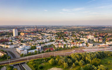 Fototapeta na wymiar aerial view of the city of rostock, railway tracks, river warnow and power plant chimney in the background
