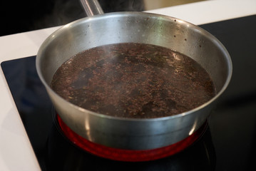 Preparing food on casserole pan on a electric stove, close-up. Cook egg process