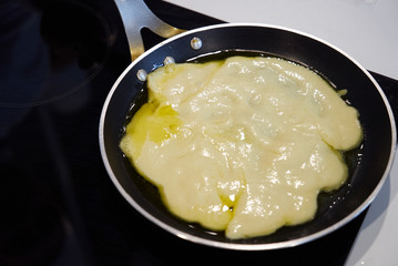 Preparing food on frying pan on a electric stove, close-up