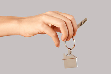 real estate concept hand giving a house key 