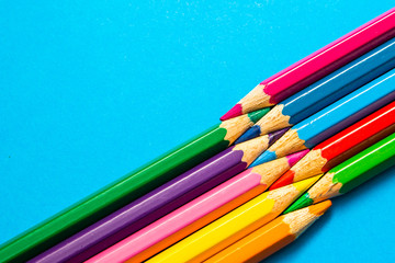 Color pencils isolated on blue background, colorful fun back to school stationery, colour pencils arranged on colourful background